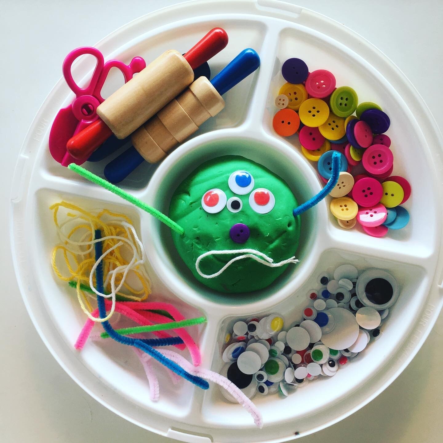 I have a bin filled with PlayDoh and tools but I don’t hand the bin over to try kids. I use this tray and add some PlayDoh, some tools, and small parts like string, pipe cleaners, buttons and eyes and invited them to create monsters.